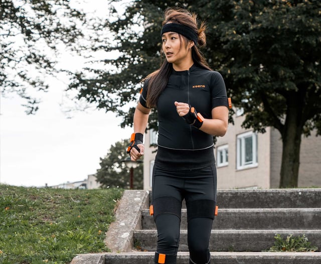 Girl wearing awinda suit going down the stairs