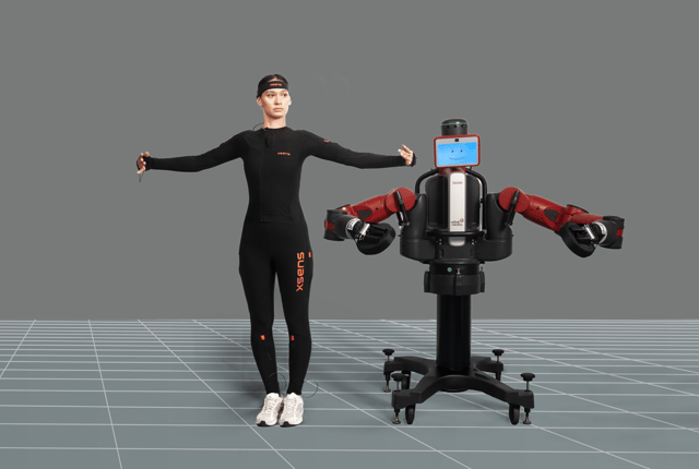 Women wearing Xsens Link suit next to a robot